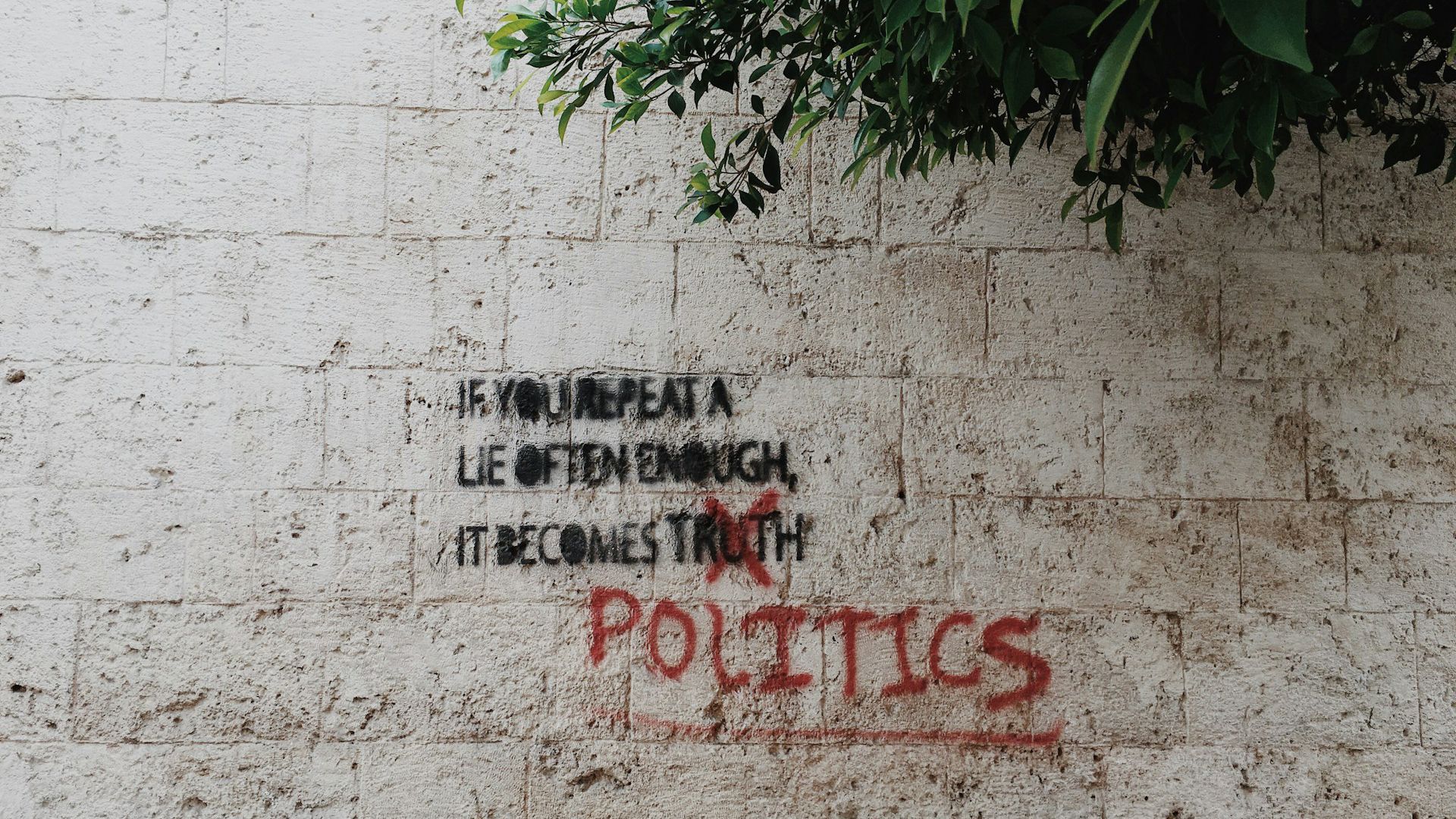 Photo of a graffiti that says If you repeat a lie often enough, it becomes politics